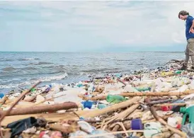  ?? Associated Press file photo ?? This photo provided by The Ocean Cleanup shows The Ocean Cleanup’s founder and CEO Boyan Slat among the trash on the Rio Motagua in Guatemala in 2022.