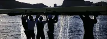  ?? DAVID GOLDMAN/THE ASSOCIATED PRESS ?? Rowers from Great Britain dump water out of their boat after a practice session at the rowing venue Sunday.