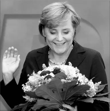  ?? MICHAEL KAPPELER / AFP / GETTY IMAGES ?? Despite receiving a bouquet from supporters yesterday, Angela Merkel has lost her standing among Christian Democrats.