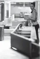  ??  ?? Hayley Winningham checks packages as they pass by her on a conveyor belt at the Fedex Ground Olive Branch hub.