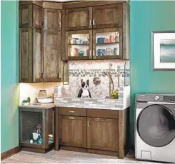  ?? WELLBORN CABINET ?? A pet-friendly laundry room can include a kennel and a toe-kick feeder that hides away under the cabinets.