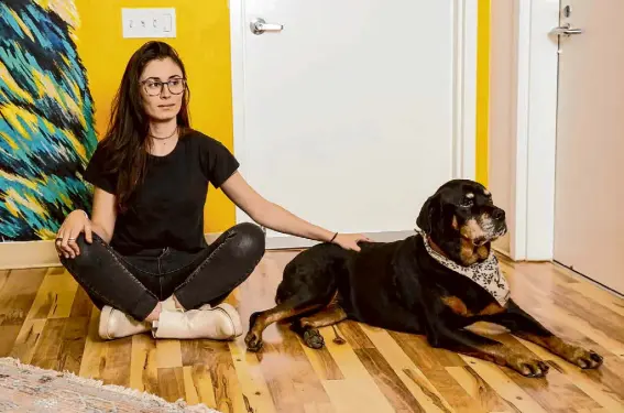  ?? Salgu Wissmath/The Chronicle ?? The founder and CEO of Loyal, Celine Halioua, relaxes with her Rottweiler, Della, on Dec. 21, 2022.