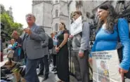  ?? THE ASSOCIATED PRESS ?? The Reverend Patrick Mahoney from Washington, D.C., foreground left, speaks to the media outside the Royal Courts of Justice in London, as he joins other Charlie Gard supporters on Sunday.