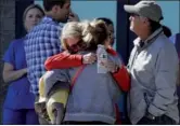  ?? JOHN LOCHER / AP ?? Two women embrace outside of a family assistance center on Monday in Las Vegas. The makeshift center was set up to help families and others reconnect after the mass shooting near the Las Vegas Strip.