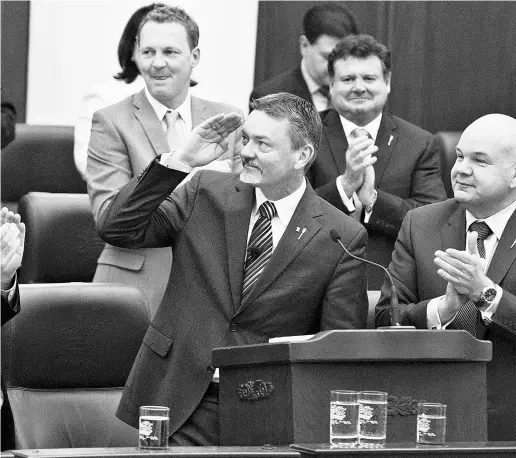  ?? JasonFrans­on/ The Cana dianPres ?? Alberta Finance Minister Doug Horner salutes the crowd after delivering the 2014 budget in Edmonton on Thursday.