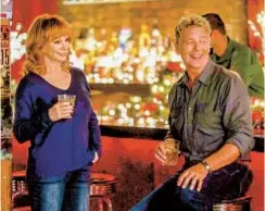  ?? LIFETIME ?? Reba McEntire and John Schneider in the Lifetime holiday special “Reba McEntire’s Christmas in Tune.”