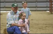  ?? Not Provided / Fort Morgan Times ?? Marlin Eisenach, the CSU Extension Agent in charge of livestock, asks a participan­t in the open class bottle calf, lamb and goat event at the 2021 Morgan County Fair a few questions.