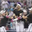  ?? AP photo ?? Lourdes Gurriel Jr. of the Diamondbac­ks celebrates with teammates after hitting a walk-off double in the ninth inning Sunday.