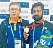  ?? HT PHOTO ?? Silver medal winner Gurpreet Singh (above right) with pistol coach Pavel Smirnov. Vijayveer Sidhu (left) with his two gold medals won on Friday at the World Shooting Championsh­ips.