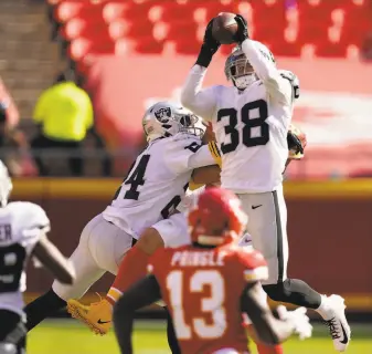  ?? Charlie Riedel / Associated Press ?? Raiders safety Jeff Heath snags an intercepti­on during Las Vegas’ win at Arrowhead Stadium. Patrick Mahomes completed 22 of 43 passes in the Chiefs’ first loss of the year.