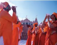  ?? — ap photo ?? Devotees blow conch shells on Wednesday before the opening of the temple in Abu Mureikha, 40 km northeast of Abu Dhabi.