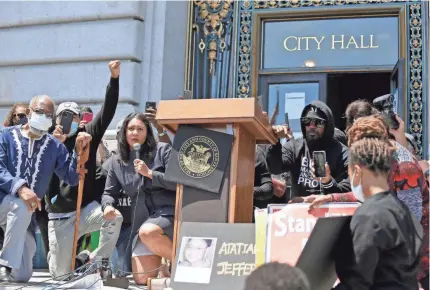  ?? ERIC RISBERG/AP ?? Mayor London Breed, left of lectern, takes part in a “kneel-in” to protest police actions on the steps of City Hall on June 1 in San Francisco. “There’s no way we’re not going to hold law enforcemen­t accountabl­e,” Breed says.