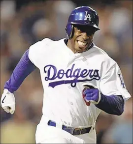  ?? Alexander Gallardo Los Angeles Times ?? KENNY LOFTON, who played one of his 17 major league seasons with the Dodgers, compares his statistics to those of Hall of Famer Tim Raines.