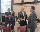  ?? GAVIN KEEFE DAY PHOTO ?? UConn women’s basketball coach Geno Auriemma, left, and men’s basketball coach Dan Hurley, second from right, attended Wednesday’s board of trustees meeting at Storrs.