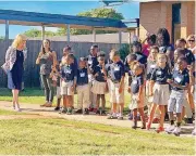  ?? CARLA HINTON, THE OKLAHOMAN] [PHOTO BY ?? Robin Khoury, founder and principal of Little Light Christian School, watches as the school’s students sing songs and recite the school’s creed during the Oct. 7 dedication of the school’s new campus in Oklahoma City.