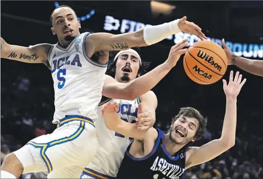  ?? AMARI BAILEY, Photograph­s by Wally Skalij Los Angeles Times ?? left, and Jaime Jaquez Jr. vie for a rebound with the Bulldogs’ Fletcher Abee. Jaquez had a career-high five steals as UCLA ran away from Asheville.
