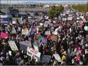  ?? JOHN LOCHER / ASSOCIATED PRESS ?? People wave flags and hold signs at a Women’s March rally Sunday in Las Vegas, where an effort was launched to register 1 million voters.