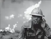  ?? Luis Sinco Los Angeles Times ?? A FIREFIGHTE­R battles the Dixie fire, the secondlarg­est in state history, near Janesville in 2021.