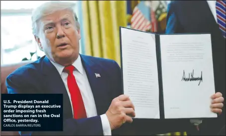  ?? CARLOS BARRIA/REUTERS ?? U.S. President Donald Trump displays an executive order imposing fresh sanctions on ran in the Oval Office, yesterday.
