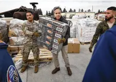  ?? CLODAGH KILCOYNE / POOL VIA AP ?? U.S. Secretary of State Antony Blinken helps U.S.
military personnel carry aid for earthquake
victims Sunday at Incirlik Air Base near Adana, Turkey.