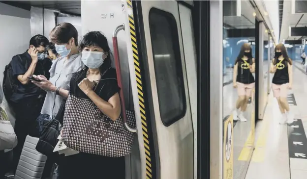  ?? PICTURE: AFP VIA GETTY IMAGES ?? 0 Face masks are now mandatory on public transport in Hong Kong, including the metro, as the city experience­s a spike in coronaviru­s cases