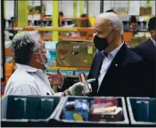  ?? PATRICK SEMANSKY — THE ASSOCIATED PRESS ?? President Joe Biden talks with a volunteer at the Houston Food Bank on Friday in Houston.