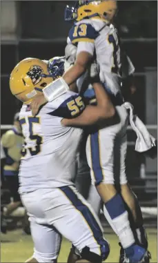  ?? PHOTO CORISSA IBARRA ?? Brawley quarterbac­k Ethan Gutierrez and tackle Julius Diaz celebrate their victory Friday against Central Union High School in the annual Bell Game.