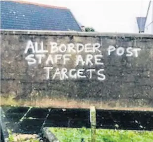  ??  ?? Anti-border post graffiti daubed on a wall close to Larne Port