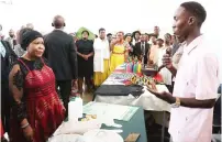  ?? ?? First Lady Dr Auxillia Mnangagwa listens to former street children as they explained how they can now make various types of products and kitchen utensils among other things from recycled waste following the training they received at her skills developmen­t centre in Mbare yesterday