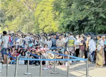  ?? STR/AGENCE FRANCE-PRESSE ?? PEOPLE gather outside the embassy of Thailand to get visas in Yangon on 16 February 2024, after Myanmar’s military government said it would impose military service.