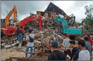  ?? (AP/Azhari Surahman) ?? Rescuers search for survivors Friday in a quake-collapsed building in Mamuju on Indonesia’s Sulawesi island.