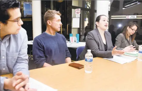  ?? Arnold Gold / Hearst Connecticu­t Media file photo ?? From left, Melvin Medina, advocacy and outreach director for the ACLU of Connecticu­t, and Dan Barrett, legal director, listen to attorney Ellen Messali of New Haven Legal Assistance speak about how to interact with police during a discussion at the Consulate General of Ecuador in New Haven in 2016. At right is Cristina Velasquez acting as an interprete­r.