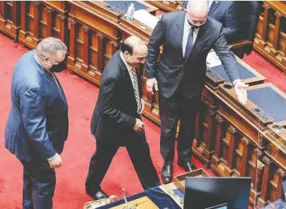  ?? DON CRaIG/ GOVERNMENT OF B.C. ?? Raj Chouhan, MLA for Burnaby-Edmonds, centre, is escorted to the Speaker's chair as the new Speaker of the British Columbia legislatur­e on Monday, during the first session held since the NDP was re-elected in October.