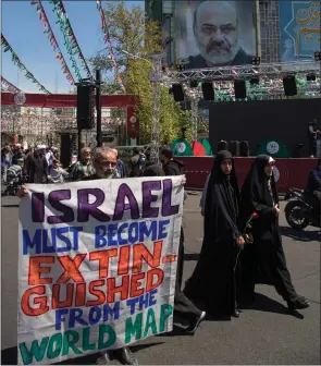  ?? Picture: Getty Images ?? Above, People attend the funeral procession for Islamic Revolution­ary Guard Corps members killed in a strike in Syria, which Iran blamed on Israel