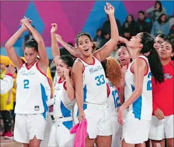  ?? MARTIN MEJIA/AP PHOTO ?? Puerto Rico teammates, including New London’s India Pagan (front, 33) celebrate at the end of their women’s basketball bronze medal match Saturday against Colombia at the Pan American Games in Lima, Peru. Puerto Rico beat Colombia 66-55 to take the bronze.