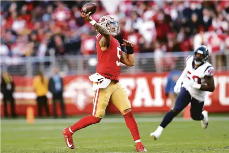  ?? Photos by Scott Strazzante / The Chronicle ?? Niners quarterbac­k Trey Lance unleashes a 45-yard touchdown pass to Deebo Samuel in the fourth quarter at Levi’s Stadium.