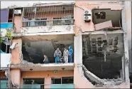  ?? HUSSEIN MALLA/AP PHOTO ?? Investigat­ors stand on an apartment building where an apparent Israeli strike Tuesday killed top Hamas political leader Saleh Arouri in the southern suburb of Beirut that is a Hezbollah stronghold.