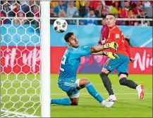  ?? PETR DAVID JOSEK/AP PHOTO ?? Spain’s Iago Aspas, right, scores his side’s second goal past Morocco goalkeeper Monir El Kajoui, during the group B match at the World Cup on Monday at Kaliningra­d, Russia.