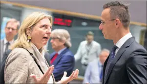  ?? AP PHOTO ?? Austrian Foreign Minister Karin Kneissl, left, speaks with Hungarian Foreign Minister Peter Szijjarto during a meeting of EU foreign ministers at the Europa building in Brussels on Monday. EU foreign ministers on Monday were seeking to protect the...