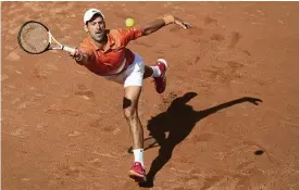  ?? AP PHOTO ?? Serbia’s Novak Djokovic returns the ball to Greece’s Stefanos Tsitsipas during their match at the Italian Open in Rome, Sunday. Djokovic won in straight sets.