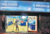  ?? REUTERS ?? A worker cleans a mobile store of Reliance Communicat­ions Ltd, controlled by billionair­e Anil Ambani