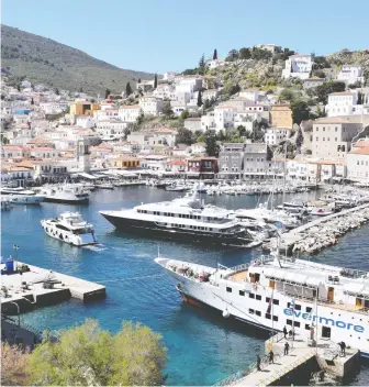  ?? STEVE MACNAULL ?? The view of Hydra's harbour combines “sugar cube” houses and super yachts.