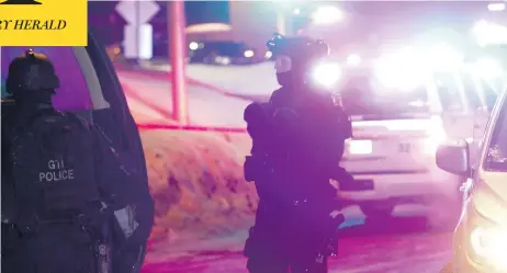  ?? FRANCIS VACHON / THE CANADIAN PRESS ?? Police monitor the scene of Sunday night’s shooting at a Quebec City mosque. Gunmen opened fire during evening prayers, killing five people.