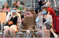  ?? AFP photos ?? travellers wait at the departure hall of Changi internatio­nal airport in singapore on thursday. —