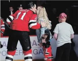  ?? ASSOCIATED PRESS FILE PHOTO ?? New JerseyDevi­ls centre Brian Boyle kisses his wife, Lauren Bedford, after he participat­ed in the ceremonial puck drop during the first period of a game against the Vancouver Canucks in November 2017.