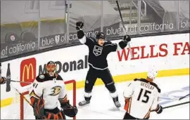  ?? Marcio Jose Sanchez Associated Press ?? KINGS wing Carl Grundstrom, center, celebrates after scoring past Ducks goalie Anthony Stolarz during the first period en route to a victory at Staples Center.