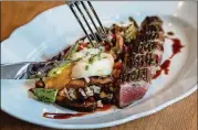  ?? CONTRIBUTE­D BY HENRI HOLLIS ?? An entree that might catch your eye at Achie’s is the duck breast with toasted rice, boiled peanut hoppin’ John, okra, shiitake mushrooms and a soft-boiled egg.