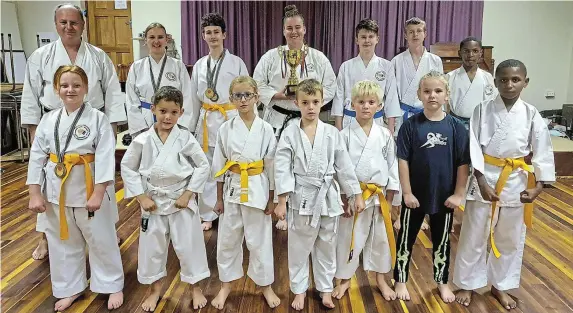  ?? Picture: BRYAN SMITH ?? WINNING SPIRIT: Some of the students from the East Cape Shotokan-Ryu who recently competed in the World Union of Karate Federation­s (WUKF) SA National Championsh­ips & Afro-Asia Open in Gqeberha, with their sensei Gary Grapentin.