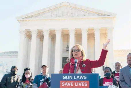  ?? JOSE LUIS MAGANA/AP ?? Former congresswo­man and gun violence survivor Gabby Giffords, D-Ariz., speaks during a rally outside the U.S. Supreme Court in Washington on Wednesday. The Supreme Court began hearing arguments in a gun rights case that centers on New York’s restrictiv­e gun permit law and whether limits the state has placed on carrying a gun in public violate the Second Amendment.