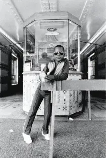  ??  ?? Photograph­s from Dawoud Bey’s 1976 series “Harlem U.S.A.” include “Three Women at a Parade, Harlem, NY,” top, and “A Boy in Front of the Loew’s 125th Street Movie Theater, Harlem, NY,” above.